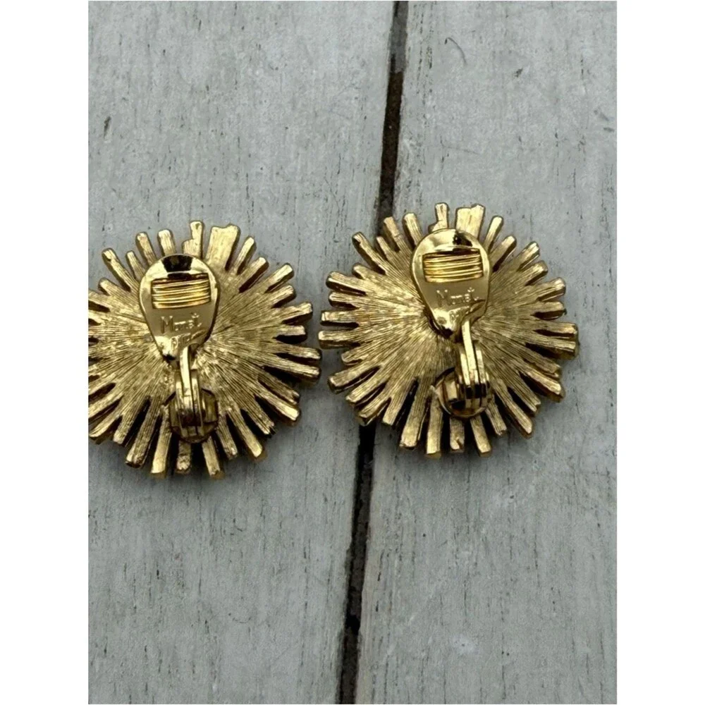 Vintage Monet gold tone starburst flower clip on earrings